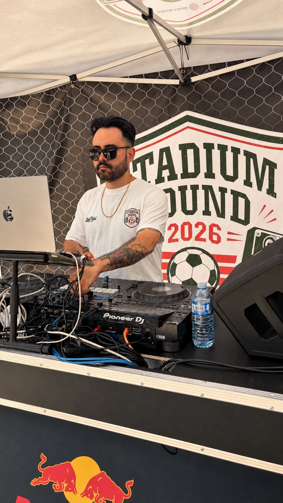The DJ wearing the Stadium Sound tee behind his decks at Liberty Matchday