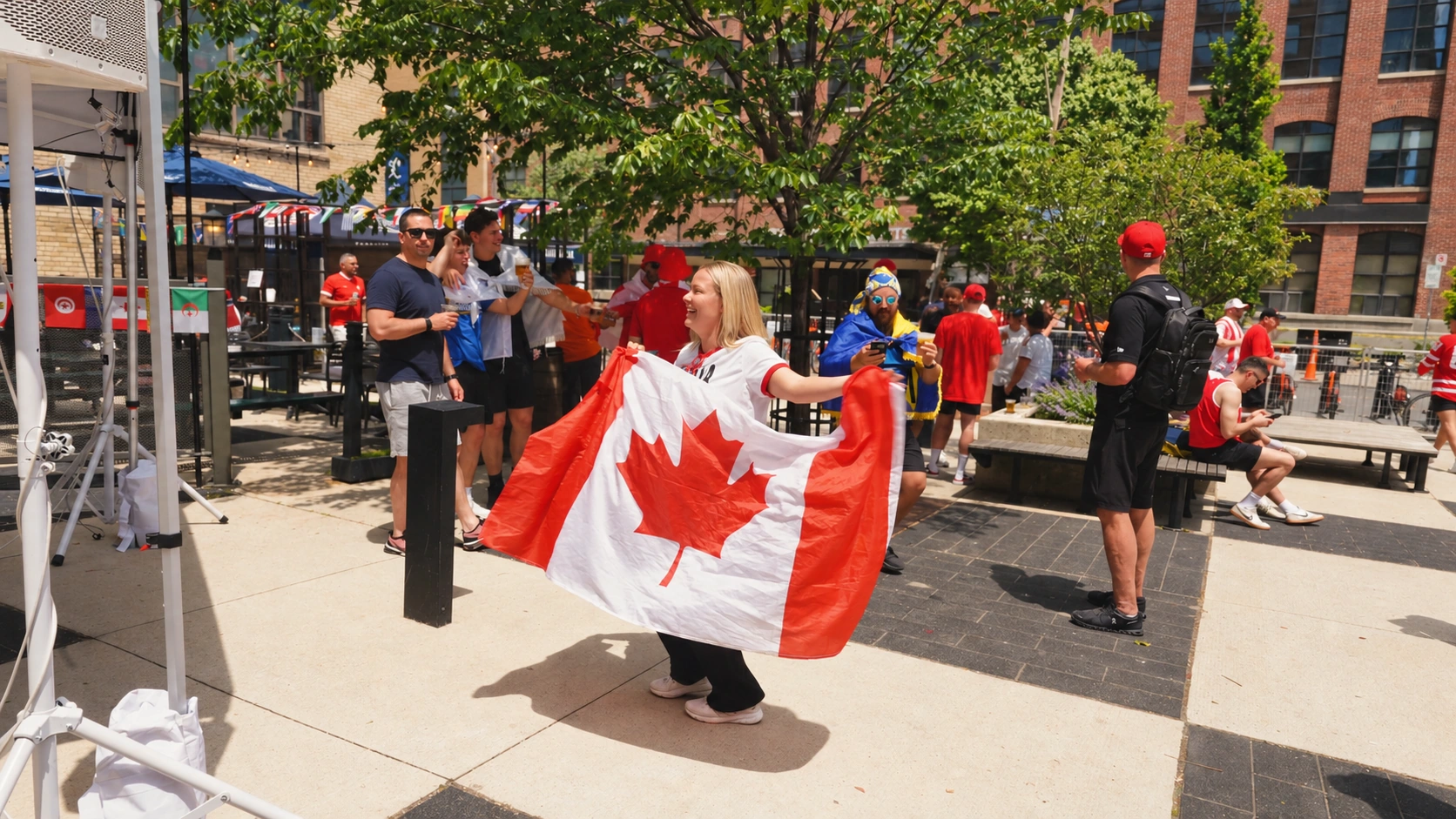 A Canada supporter holds a flag at Left Field Brewery during Liberty Matchday